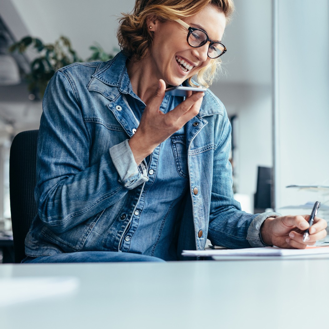 Smiling young businesswoman working at her desk
